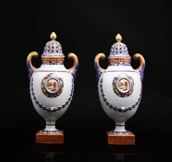 Pair of chinese export porcelain pistol handled urns with reticulated covers